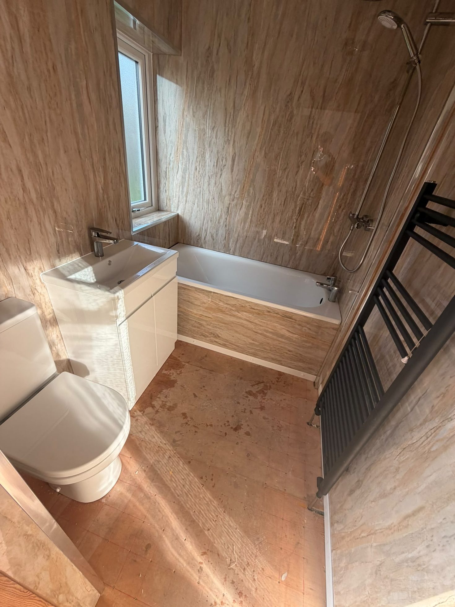 Completed bathroom renovation with bath, shower, vanity unit and wall panelling, joinery by Impact Joinery, Cumbernauld and Glasgow