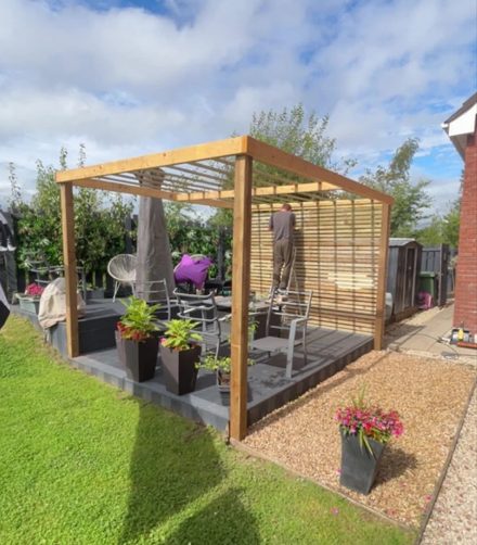 Completed timber pergola and decking structure in a back garden
