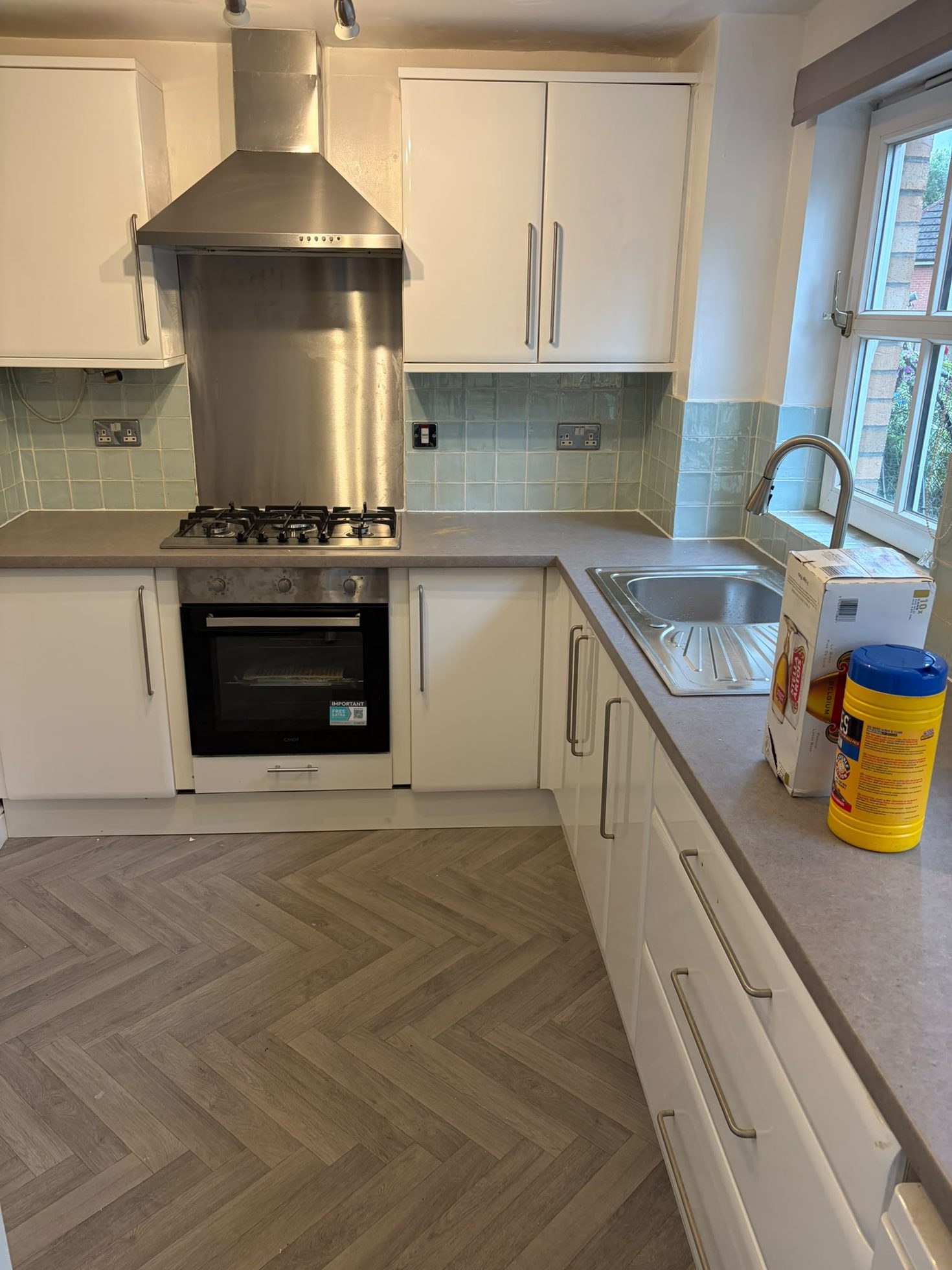Completed white kitchen installation with integrated oven, gas hob and extractor, joinery by Impact Joinery, Cumbernauld and Glasgow