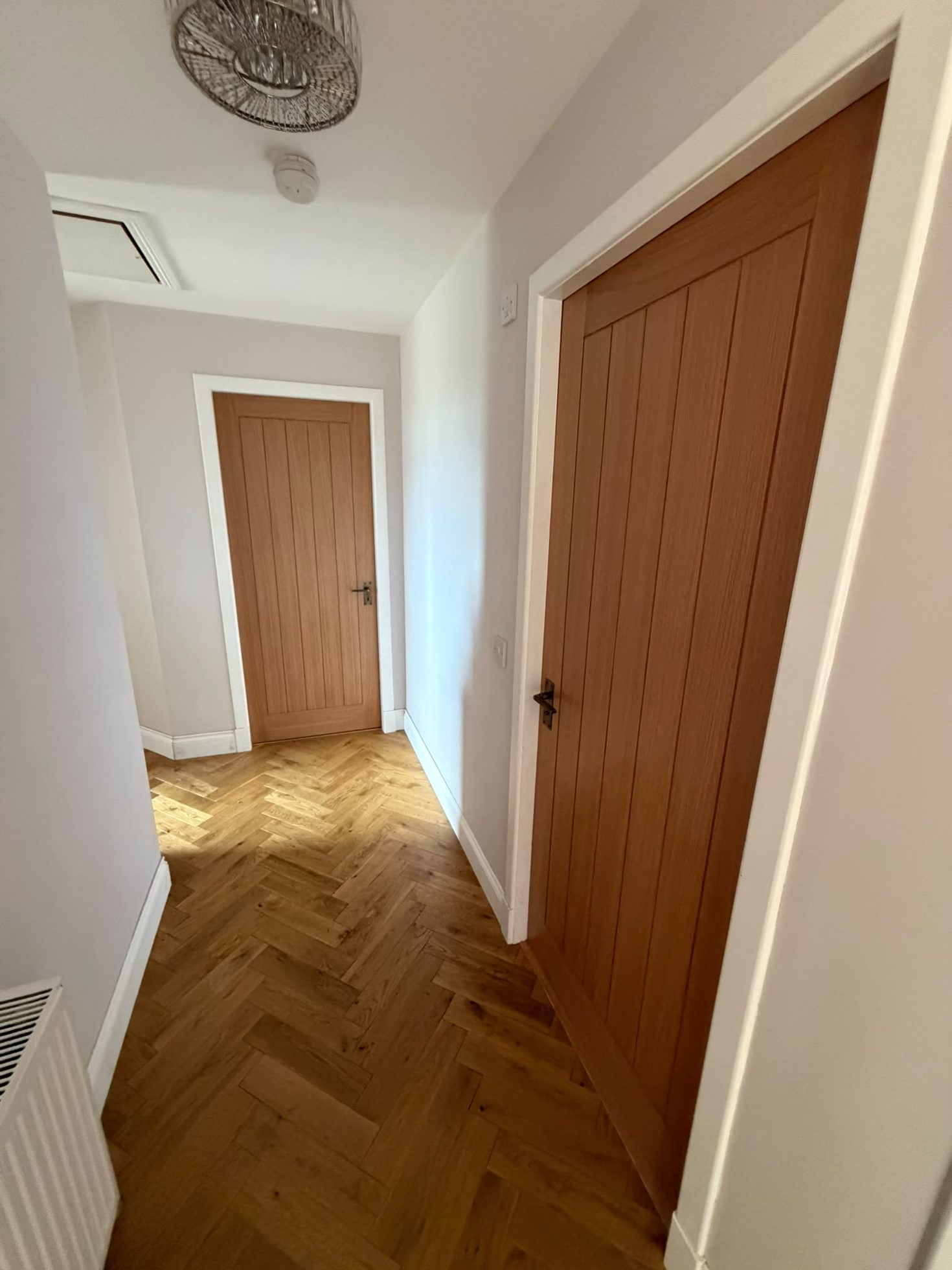 Internal timber doors hung with white trim and herringbone parquet flooring, joinery by Impact Joinery, Cumbernauld and Glasgow